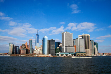 Fototapeta na wymiar Office buildings and skyscrapers on the coastline of Lower Manhattan , New York, USA. sunny day with blue sky.
