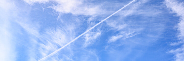 Fototapeta na wymiar background of beautiful bright blue day sky with white cloud and trail from the plane. banner