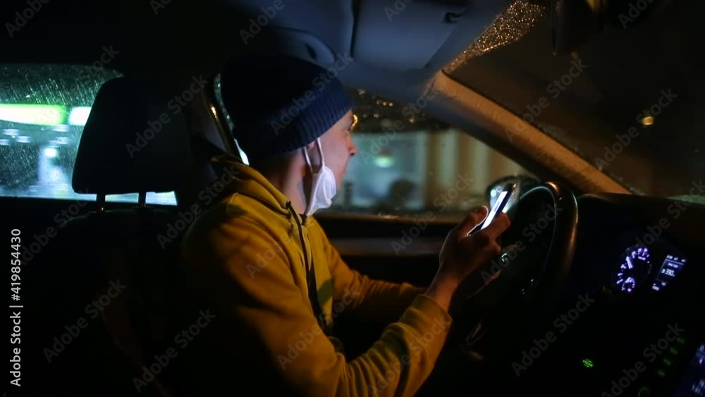 Aufkleber a man wearing a hat and ask on his beard uses a phone. he drives the car in motion. the use of elect