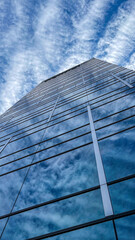 Fototapeta premium Corporate landmark skyline in modern city. Towering glass skyscrapers reflecting