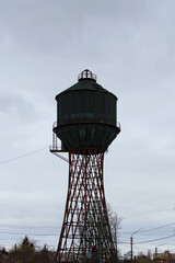 Close-up view of rusty abandoned water tank against cloudy winter sky. Bila Tserkva, Ukraine