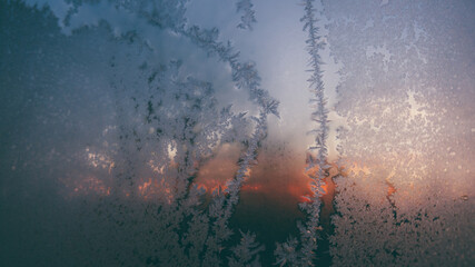 ice flowers on the window. very low temperatures in the morning during the winter season. traces of frost on the glass