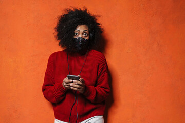 Attractive casual young african woman with headphones