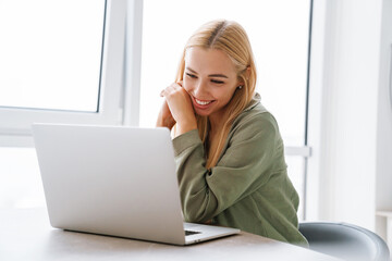 Happy smiling young woman with laptop computer