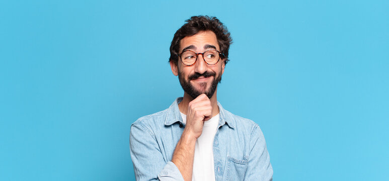young crazy bearded man. thinking or doubting expression