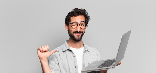 young crazy bearded man proud expression. laptop concept