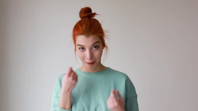 Young woman showing gesture of wasting money against blue background, materialist, shopping concept