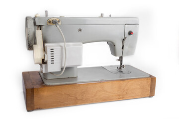 Old electric sewing machine on a white