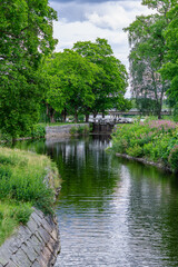 Fototapeta na wymiar Lush green summer view along the Stromsholms canal in Sweden
