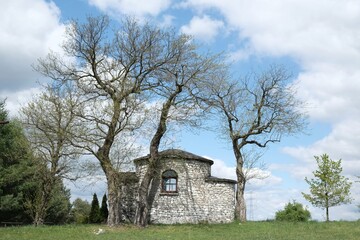 Fototapeta na wymiar Historic stone chapel of Saint Giles among fields in village of Zrebice, Jura Krakow - Czestochowa, Poland