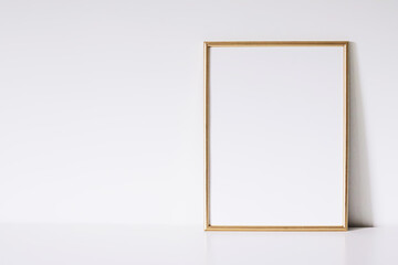 Golden vertical frame on white furniture, luxury home decor and design for mockup creation