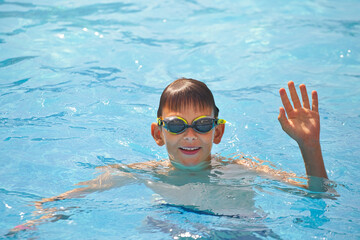 children swim in a pool with blue water