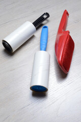 brushes for cleaning clothes. sticky and a bristled brush, lie on a light-colored countertop.