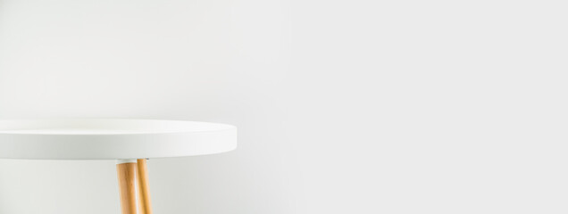 Banner empty modern round white table top at white house wall,Mockup space background for display...