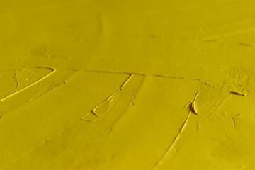 Smears of yellow putty on the surface close-up