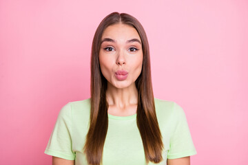 Fototapeta premium Photo of sweet funny young lady wear green t-shirt lips pouted isolated pastel pink color background