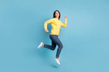 Fototapeta premium Full size photo of nice optimistic brunette long hairdo lady run wear shirt jeans sneakers isolated on blue color background