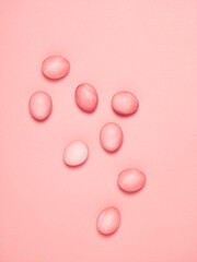 Creatively painted eggs in pastel colors on pink background. Happy Easter concept. Flat lay.