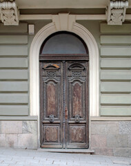 Old weathered beautiful doors. Wood carving. Wooden texture. Figure cutting on wood. Interior Retro Background. Traditional carved wooden doorway.