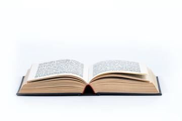 Open book isolated on white background, clipping path included. Library book with dark hard cover open on white table