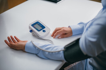 Hands with a tonometer on the table