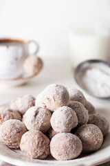 Homemade cottage cheese donuts balls with powdered sugar in a bowl on a light background. Beautiful breakfast. 