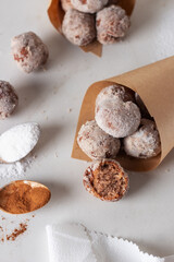  Homemade cottage cheese donuts balls with powdered sugar in a paper bag