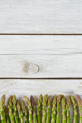 fresh green asparagus on wooden surface