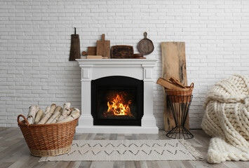Fototapety  Wicker baskets with firewood and white fireplace in cozy living room