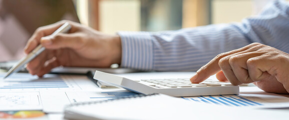 Close up of male accountant or banker making calculations. Savings money, Annual tax calculation...