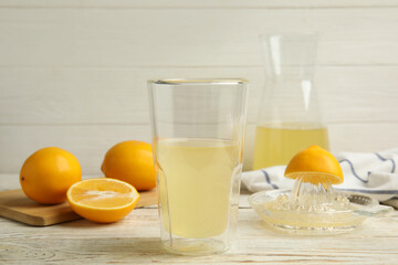 Freshly squeezed lemon juice on white wooden table