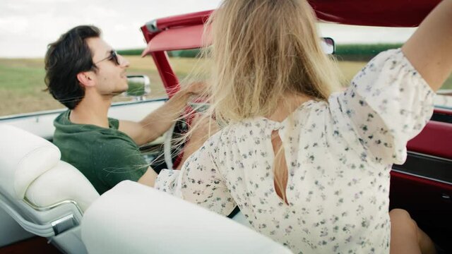 Rear view video of couple driving a car. Shot with RED helium camera in 8K.