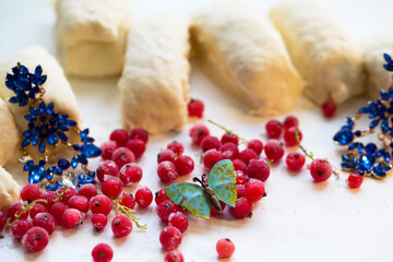 Red frozen berries are scattered around the table in the middle of the decorations. Beautiful still life.