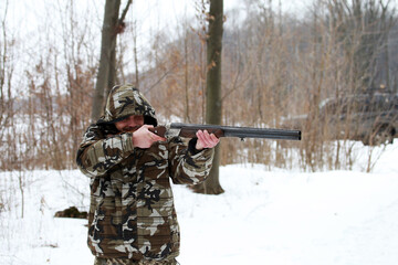 Fototapeta premium The man is shooting with a shotgun