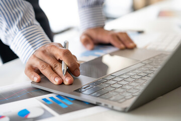 Fototapeta premium A businessman that operates on the table being checking data, Concept financial transactions online of a businessman, Financier being check about financial transaction past computer with teamwork.