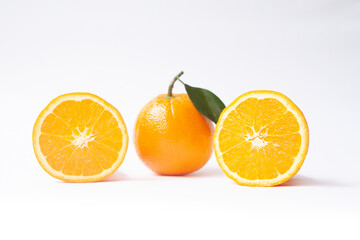 Orange fruit with juicy orange cross section. White background. Fresh citrus fruit.
