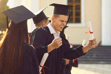 Young university graduate is happy and excited about the successful completion of his studies. Guy...