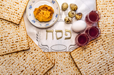 Pesah celebration concept (Jewish Passover holiday). Top view on traditional food and drink attributes. Hebrew letters, in English translation mean as Jewish Passover