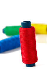 sewing items, needles, thread on white background