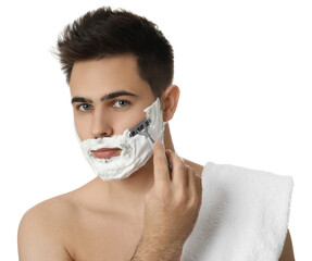 Handsome young man shaving with razor on white background