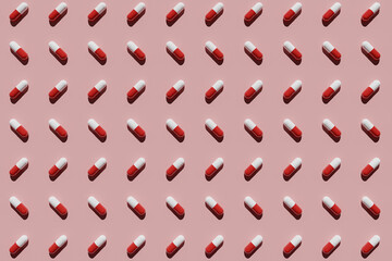 Red and white capsules on a pink background. 3D rendering