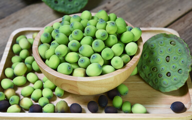 Lotus seeds in the wooden cup .