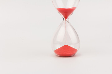 Crystal hourglass on light background as a concept of passing time for business term, urgency and...