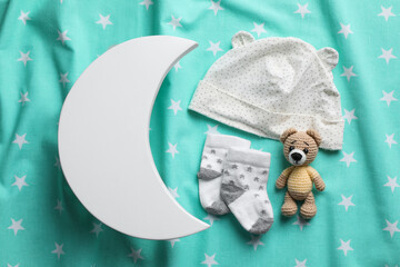Obraz na płótnie Canvas Flat lay composition with crescent shaped child's night lamp on turquoise fabric