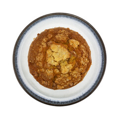 Overhead view of a single cinnamon crumb muffin on a plate isolated on a white background.
