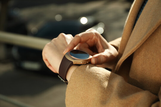 Mature Woman Using Smart Watch Outdoors, Closeup