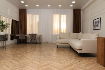 Modern living room with parquet flooring and stylish furniture