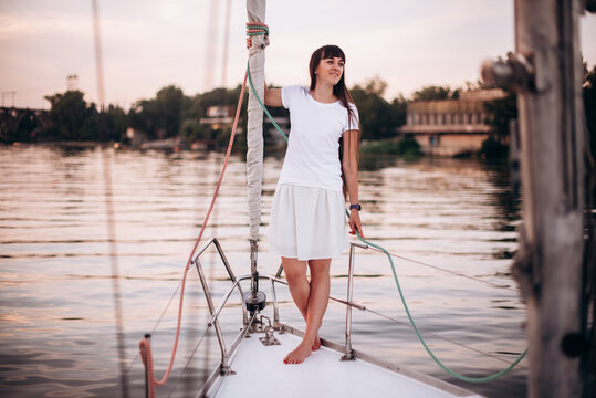 Woman in white wear staying on sailboat