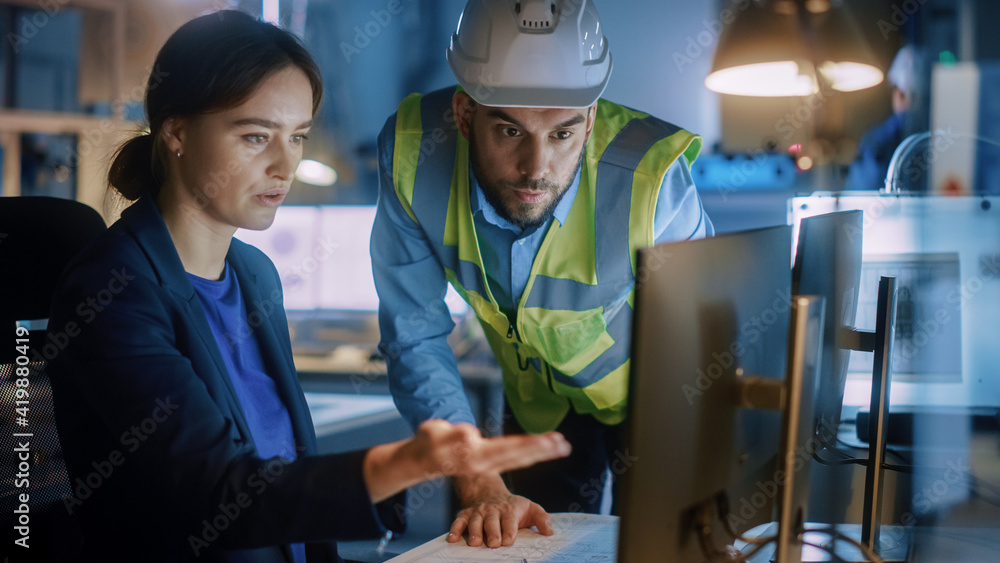 Poster Modern Factory Office: Male Project Manager Talks to a Female Industrial Engineer who Works on Computer. Professional Teamwork, Specialists Solving Problems, Finding Solutions