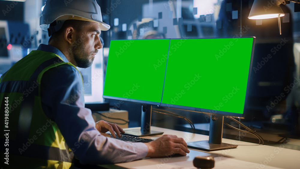 Poster Electronics Design Factory: Portrait of Handsome Male Engineer Wearing Safety Vest Working on Computer with Green Screen Chroma Key Display Great for Mock-up